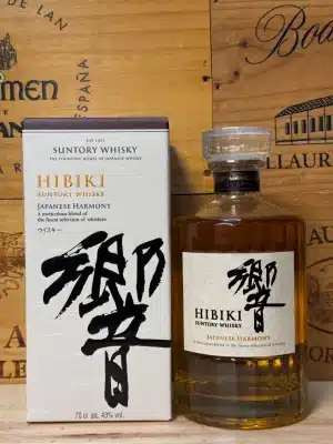 A bottle of Hibiki Japanese Harmony whisky with an elegant glass design, showcasing amber liquid inside. The label features Japanese calligraphy and a minimalist design, reflecting the whisky's refined craftsmanship.