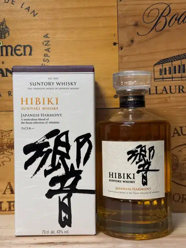 A bottle of Hibiki Japanese Harmony whisky with an elegant glass design, showcasing amber liquid inside. The label features Japanese calligraphy and a minimalist design, reflecting the whisky's refined craftsmanship.