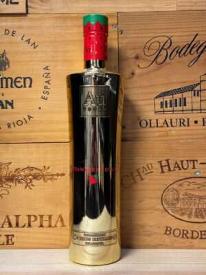 Gouden metallic fles Au Vodka Starberry Burst met sterrenontwerp en fruitige smaak van aardbei en exotisch fruit, luxe en opvallend gepresenteerd.